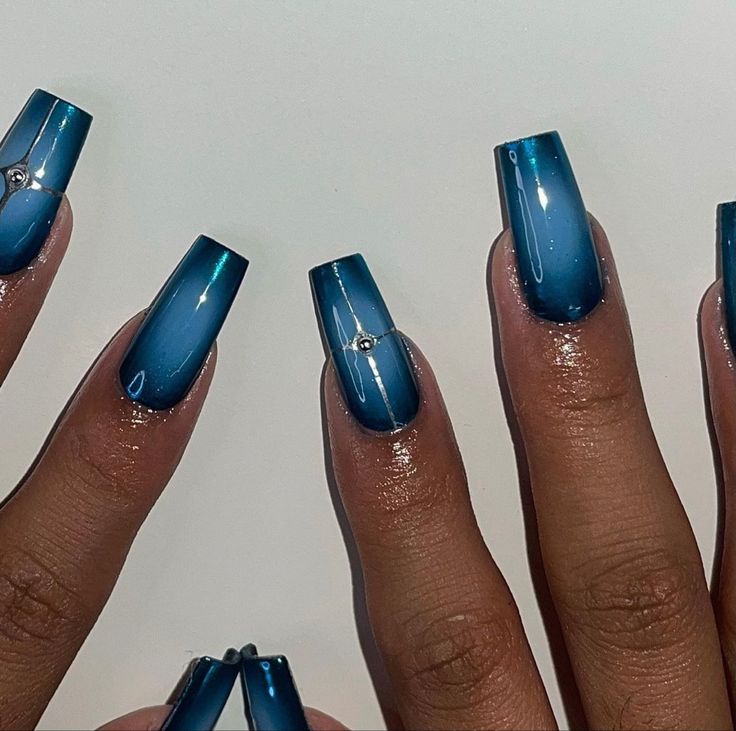 Elegant Ombre Blue Nail Design with Gradient Effect and Gem Accent.