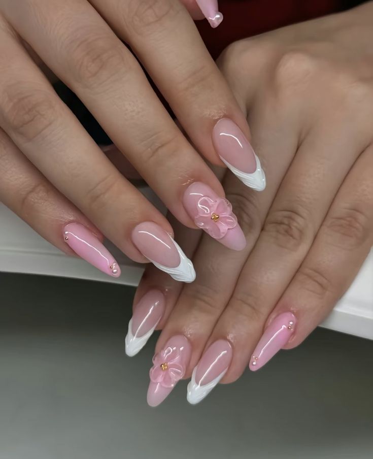 Chic Stiletto Nail Design: Soft Pink and White with Floral Embellishments and Gem Accents