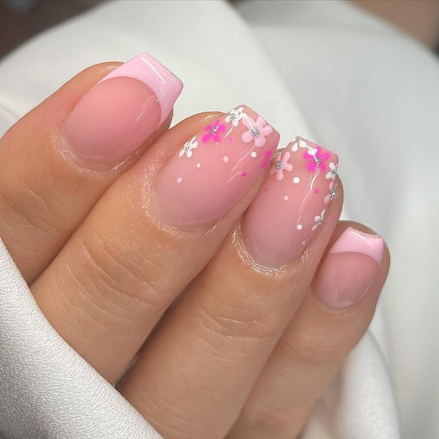 Elegant Pink Nails with French Tips and Floral Accents: A Perfect Blend of Sophistication and Whimsy.