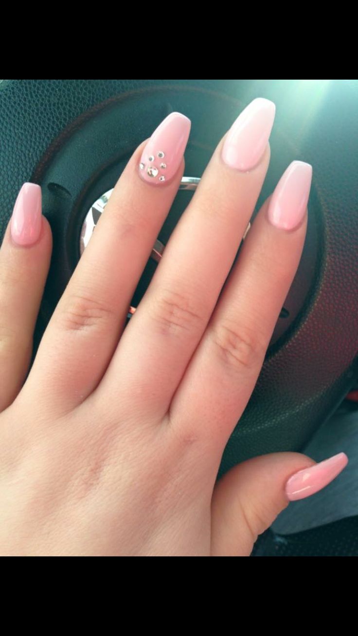 Chic Soft Pink Nail Design with Elongated Tips and Rhinestone Accent for Effortless Elegance.