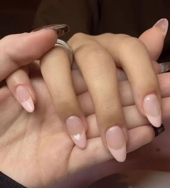 Delicate Almond-Shaped Nails with Soft Pink Gradient and Heart Accents.