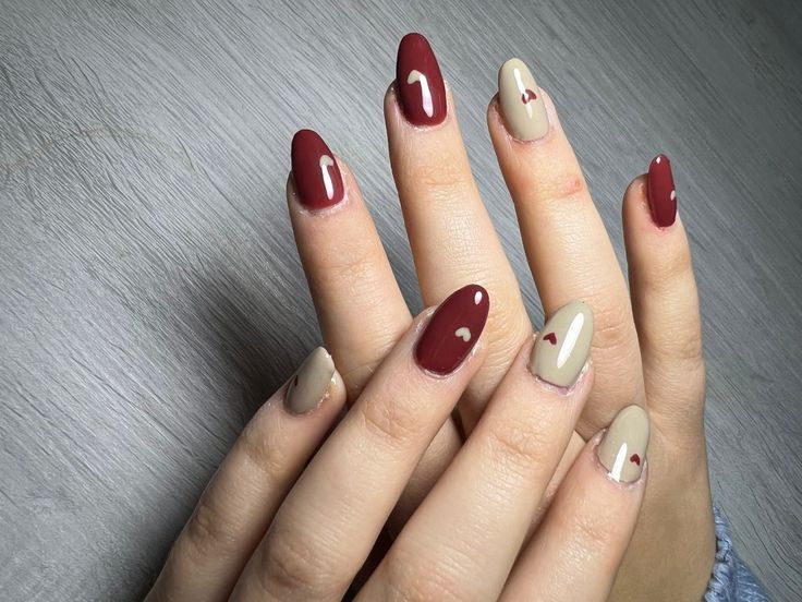 Chic Deep Burgundy and Beige Nail Design with Glossy Finish and Heart Details