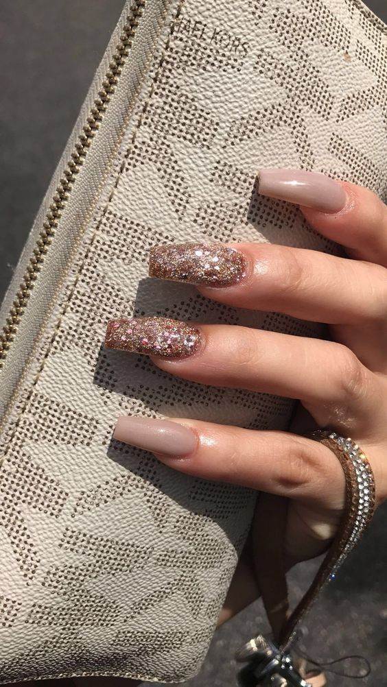 Chic Long Nails: Elegant Nude Base with Playful Glitter Accents.