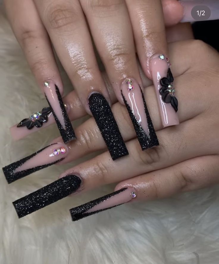 Elegant Matte Black and Nude Nail Design with Textured Finishes and Rhinestone Accents.