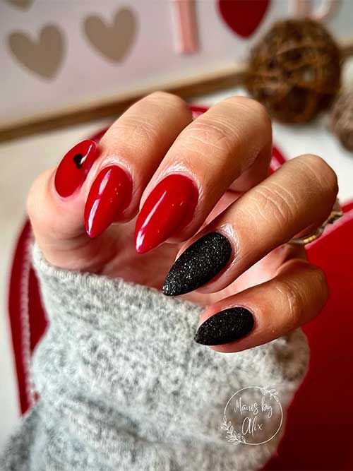 Chic Bold Nail Design: Glossy Red with Textured Black and Heart Accents.