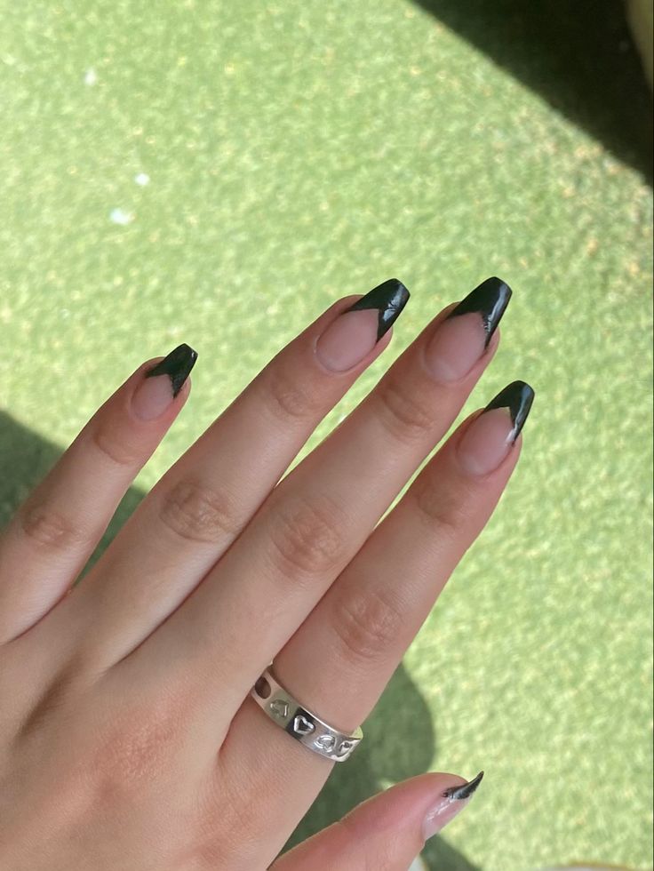 Elegant Sharp Black French Tip Nail Design on Lightly Polished Base.