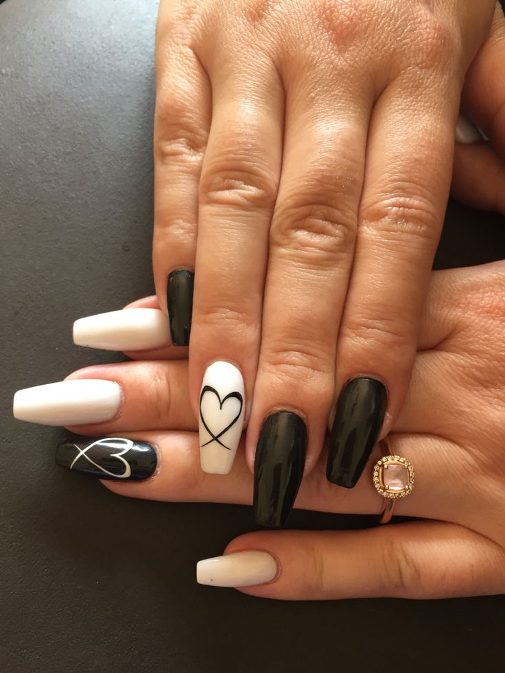 Chic Monochrome Nail Design with Glossy Black, White, and Heart Motifs