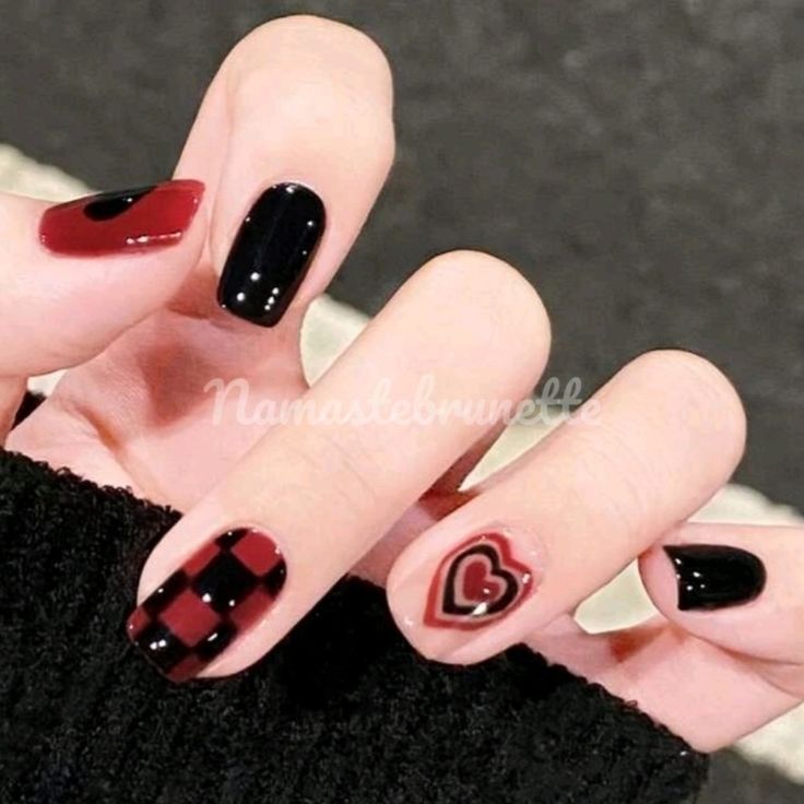 Bold Red and Black Manicure with Checkered and Heart Designs for a Playful Modern Look.