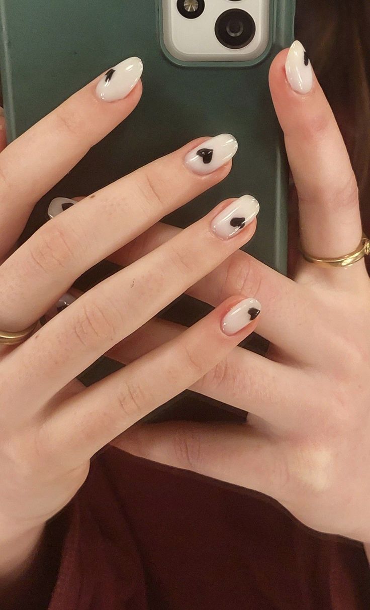 Chic White and Black Heart Nail Design: A Trendy Twist on Elegance.