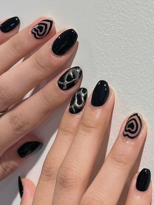 Modern Black Nail Design with Glossy and Matte Finishes in Unique Patterns