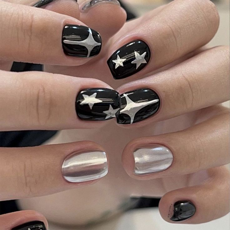 Chic Celestial Nail Design: Glossy Black and Metallic Silver Elegance