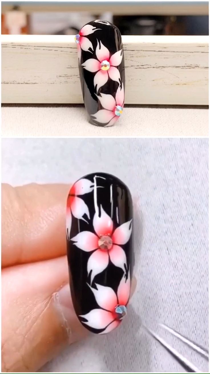 Chic Floral Nail Design with Rhinestones on Bold Black Background