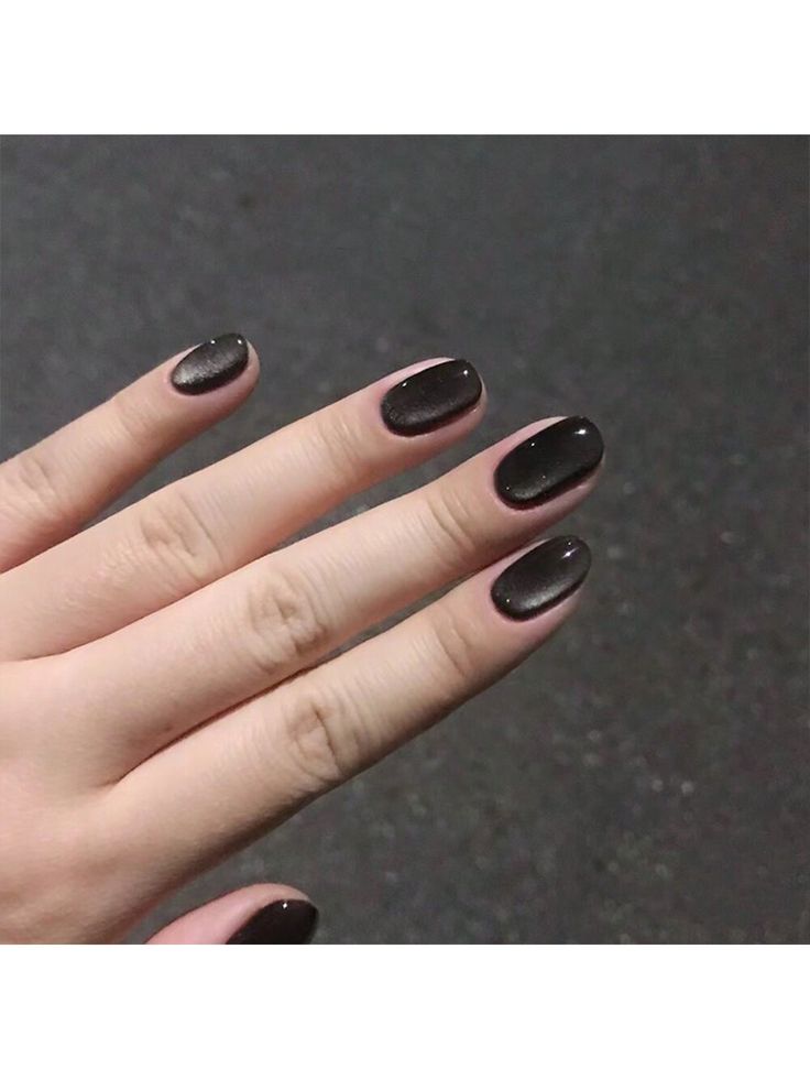 Sophisticated Oval Black Nail Design with Glossy Finish and Subtle Shimmer