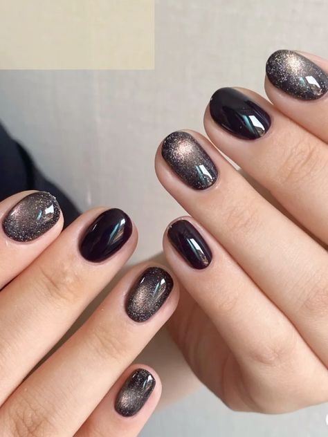 Elegant Dark Glossy Nail Design with Gradient Effects and Sparkling Tips for Any Occasion.