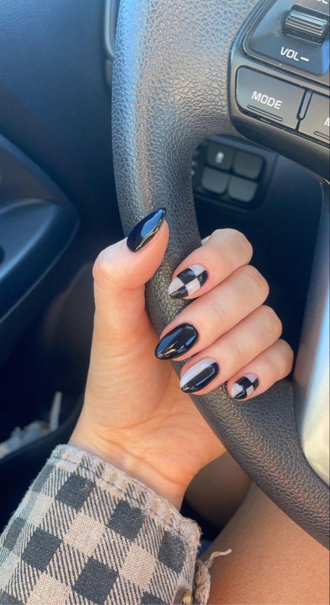 Chic Bold Nail Design with Glossy Black and Geometric Patterns.