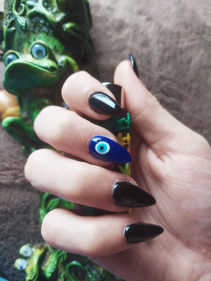 Bold and Playful Stiletto Nail Design with Eye Motif.