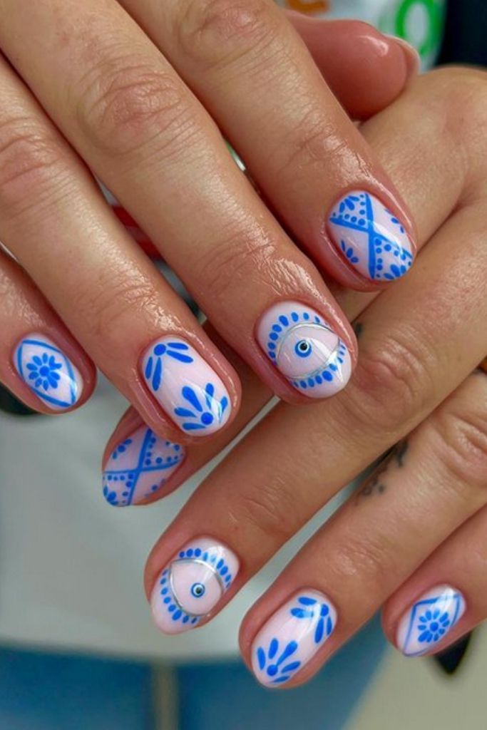 Intricate Blue Floral and Geometric Nail Design: A Stylishly Playful Elegance.