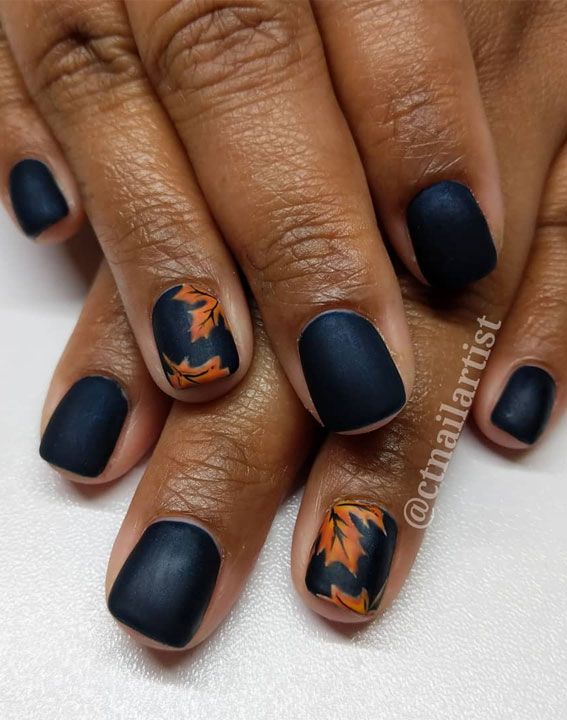 Elegant Matte Navy Nail Design with Intricate Autumn Leaves for a Seasonal Touch.