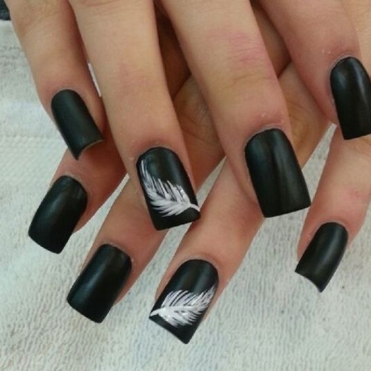 Chic Matte Black Nails with Elegant White Feather Designs: A Bold Balance of Edginess and Whimsy.