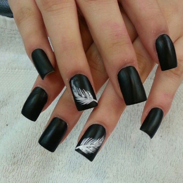 Sophisticated Matte Black Nails Enhanced by Elegant White Feather Designs.