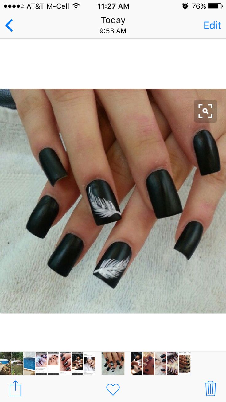 Striking Matte Black Nail Art with Elegant White Feather Accents