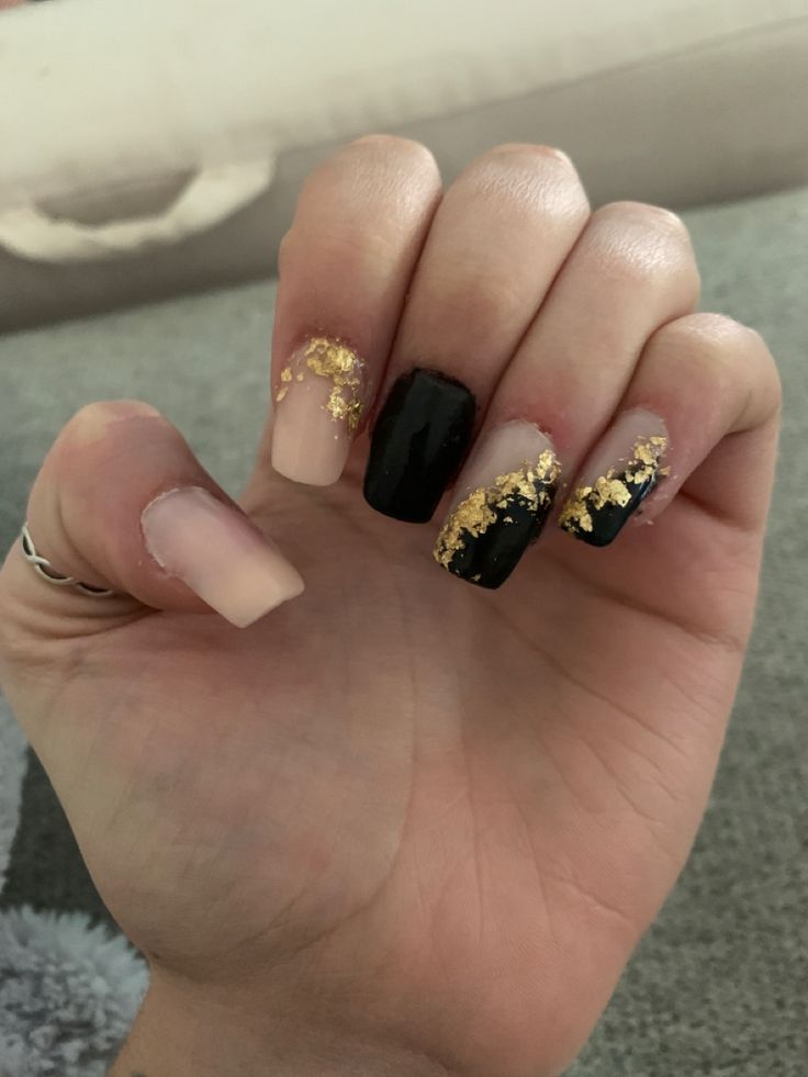 Chic Nude and Black Nail Design with Glamorous Gold Foil Accents