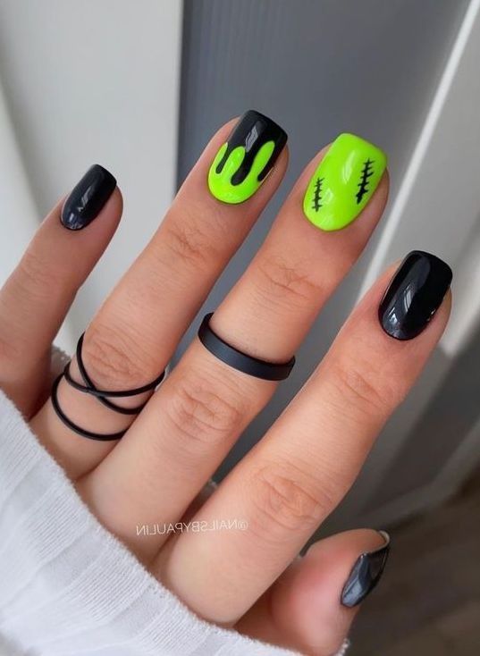 Edgy Black and Neon Green Nail Design with Slime Effects and Stitched Details.