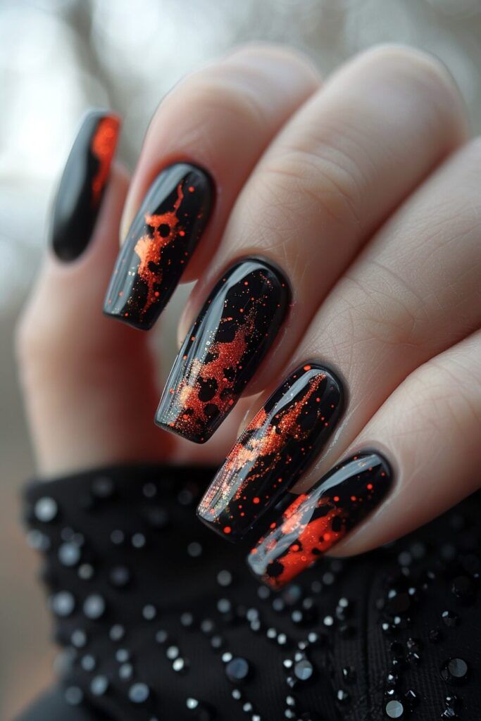 Bold Black and Orange Lava-Inspired Nail Design with Dramatic Pointed Shapes.