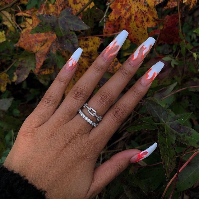 Striking Flame-Inspired Almond Nail Design with Bold Gradient Colors.