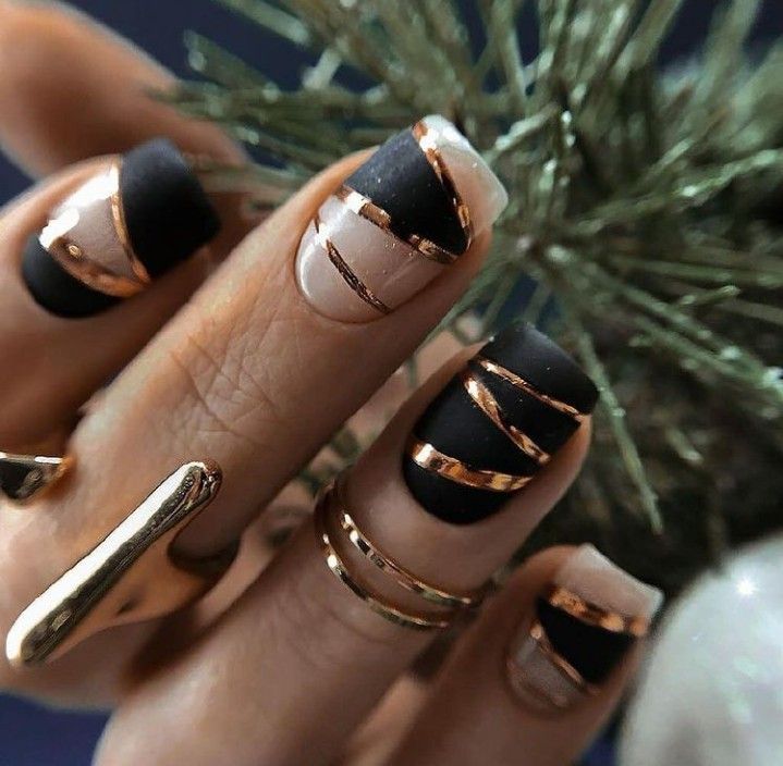 Chic Matte Black and Glossy Nude Nail Design with Glamorous Gold Foil Accents.