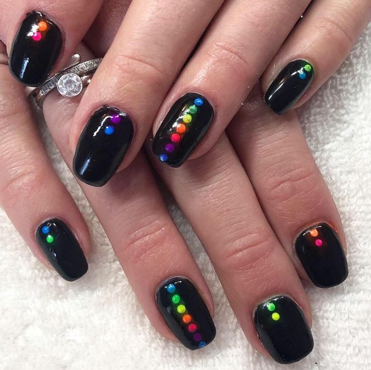 Elegant Black Nail Design with Colorful Dot Accents for a Modern Aesthetic.