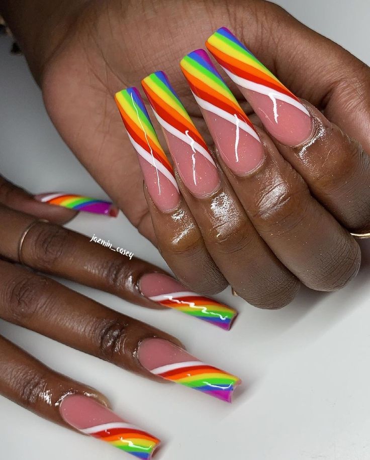 Vibrant Rainbow Stripe Nail Design on Neutral Base with Elegant White Swirls.