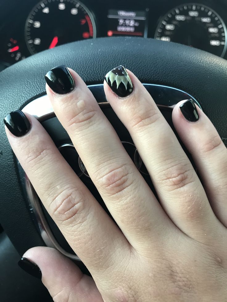 Sophisticated Black Nail Design with Creative Accent Finger.