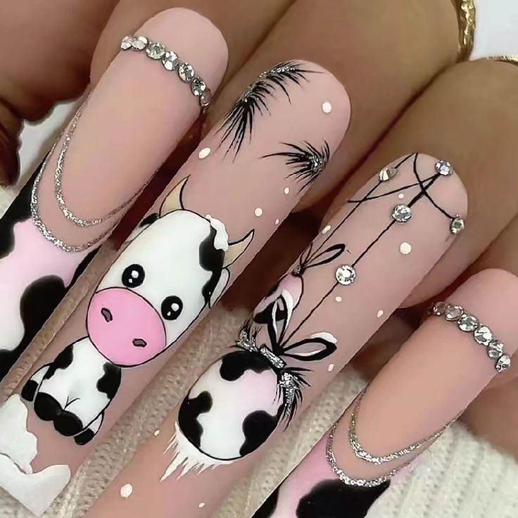 Charming Playful Cow-Themed Nail Design with Whimsical Illustrations and Rhinestone Accents.