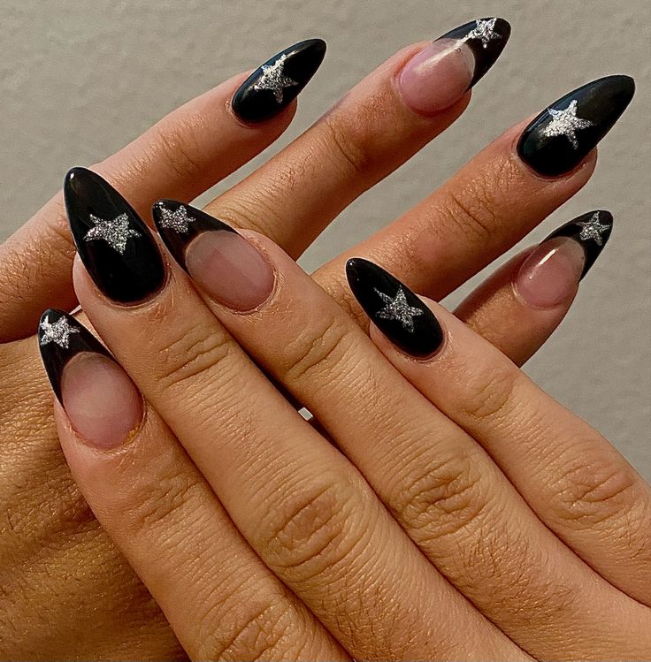 Sophisticated Stiletto Nails: Elegant Black and Clear Design with Silver Star Accents