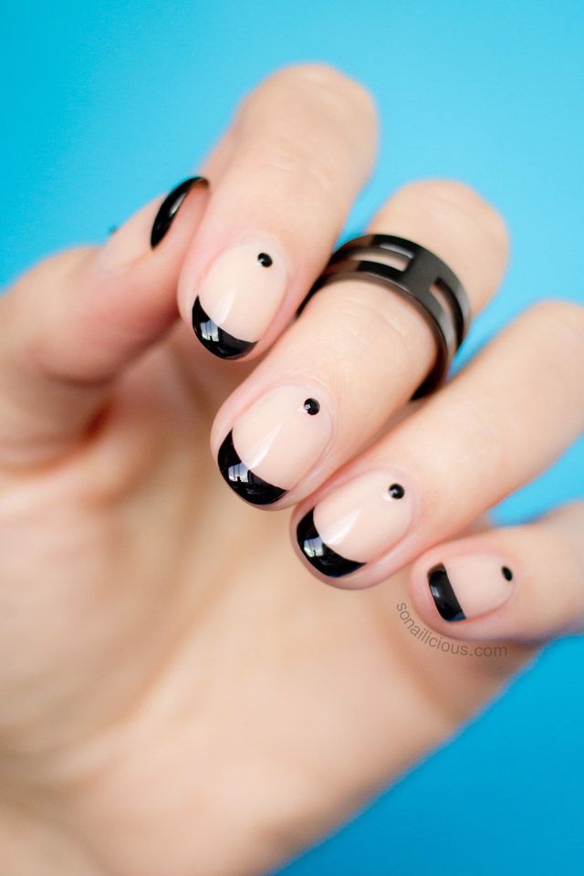 Chic French Tip Nail Design with Glossy Black Tips and Playful Accents