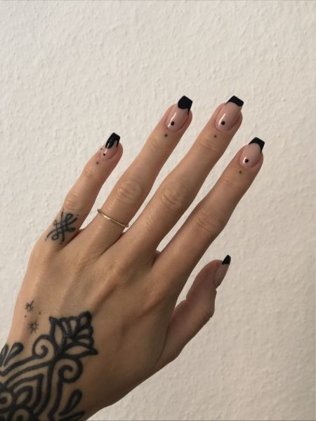 Modern French Manicure: Chic Nude Base with Striking Black Tips and Playful Dot Accents.