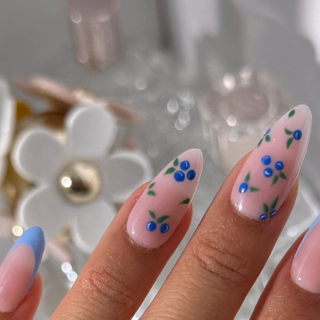 Elegant Floral Nail Design with Soft Pink, Whimsical Blue Flowers and Light Blue Tips.