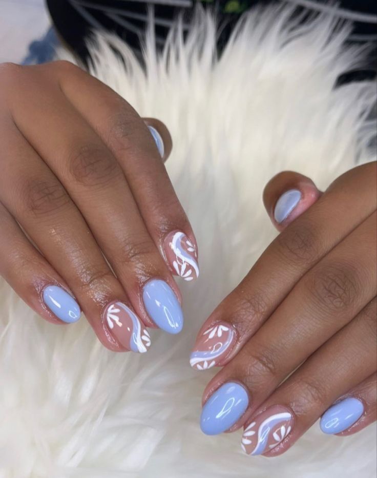 Elegant Soft Blue Nail Design with Sophisticated White Floral Patterns.