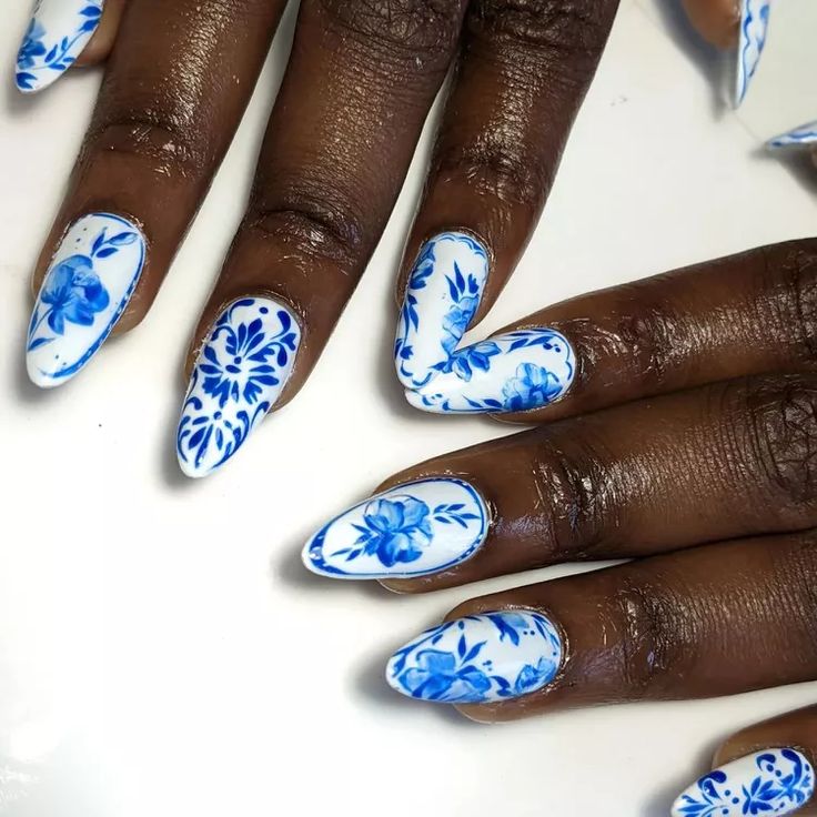 Intricate Blue Floral Nail Design on Pristine White Background for Sophisticated Style.