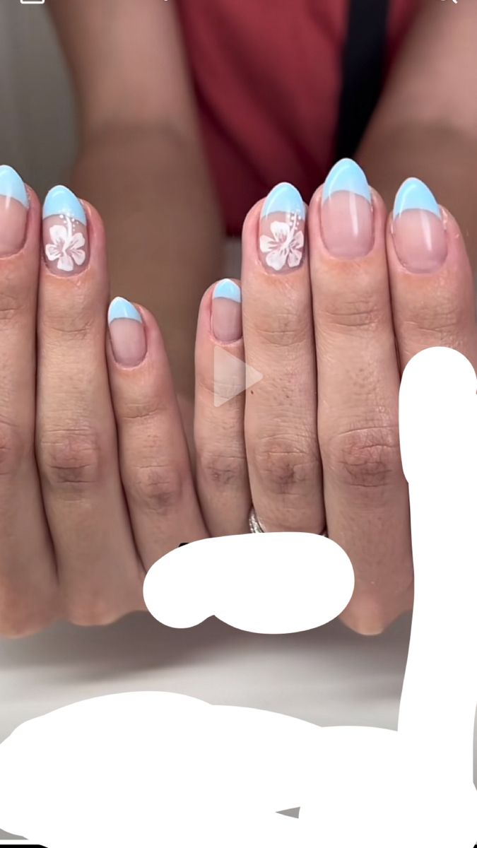 Charming Floral Nail Design with Soft Blue Tips and Delicate White Accents for Springtime Elegance.