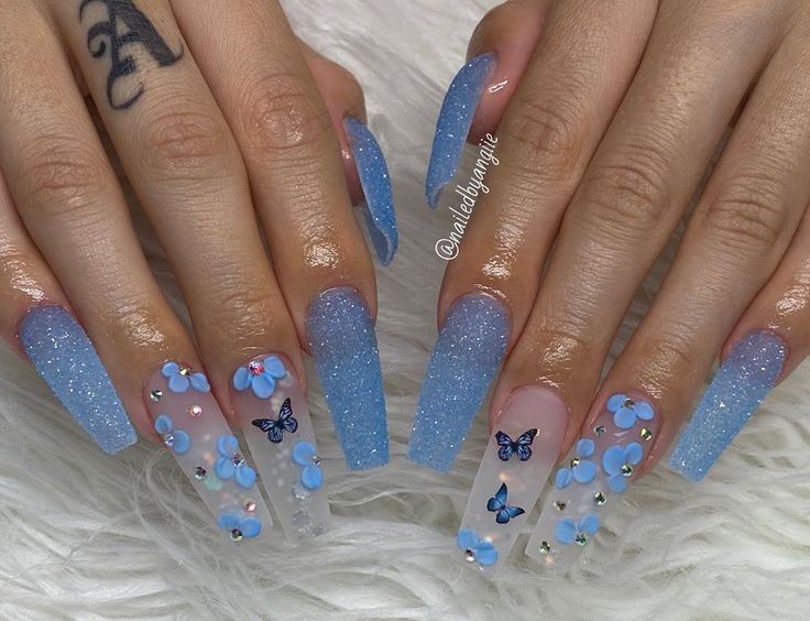 Enchanting Glittery Blue Nail Art with Butterfly and Floral Designs