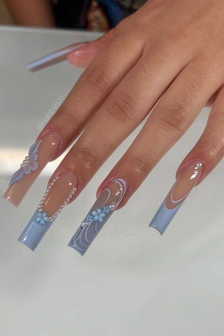 Elegant Soft Blue Floral Nail Design with Pearls and Swirls.