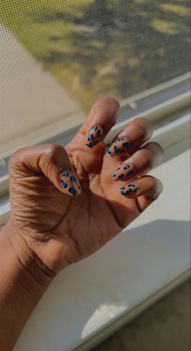 Playful Light Blue and Black Spot Animal-Print Nail Design with Glossy Finish.