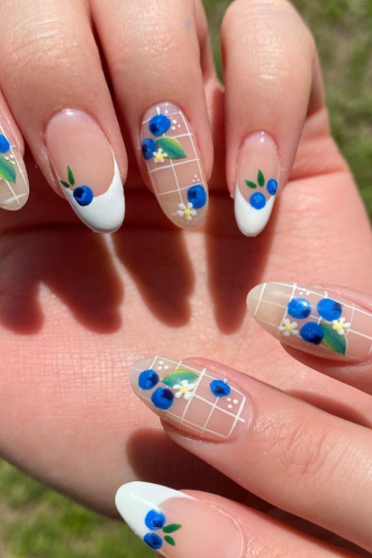 Elegant Floral Nail Design with Vibrant Blue Flowers and Glossy White Tips