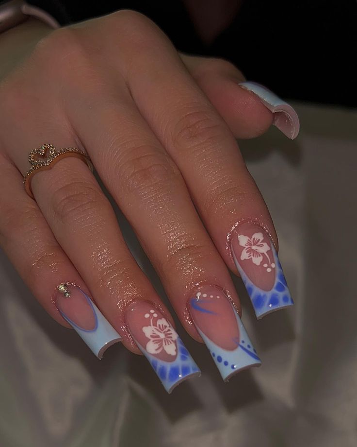 Elegant Blue Gradient Nails with Floral Patterns and Gold Accents