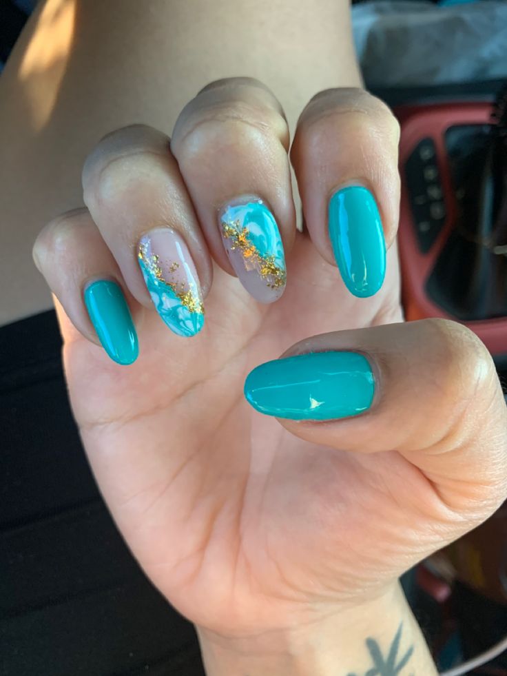 Striking Turquoise and Gold Nails with Artistic Gray and Blue Marble Design.