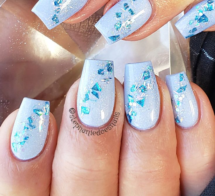 Elegant Frosted Blue Nails with Turquoise and Silver Accents.