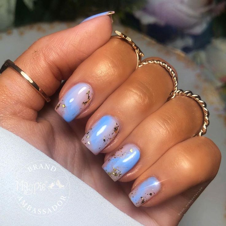 Elegant Ombre Nail Design with Lavender and Sky Blue Gradient Accented by Gold Flakes.