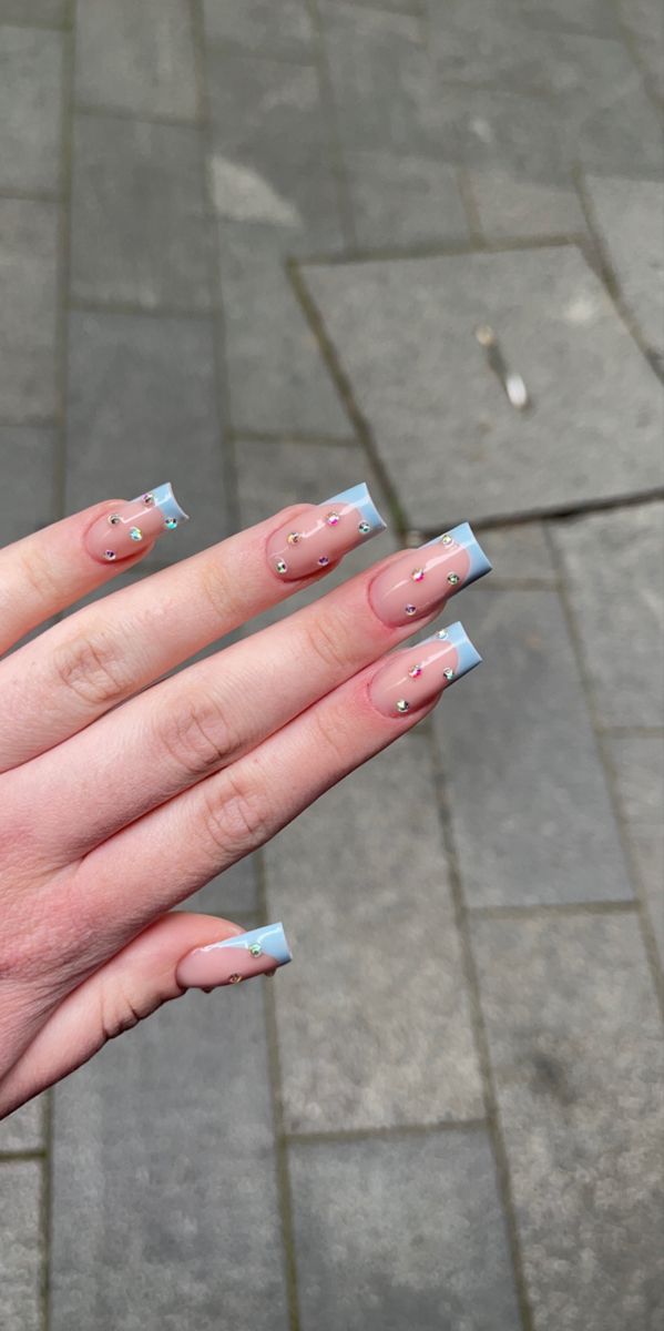 Delicate Pink and Blue Square Nail Design with Gem Accents: A Stylish and Trendy Look for Any Occasion.